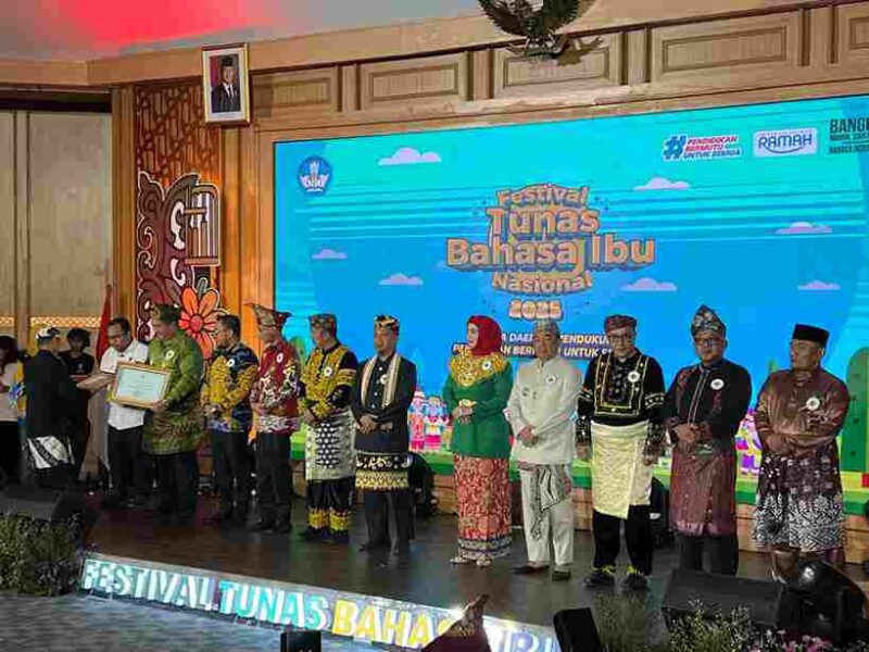 Bupati Asahan saat berdiri sebagai penerima penghargaan di Festival Tunas Bahasa Ibu Nasional (FBIN) Tahun 2025 di Depok, Jawa Barat. Senin, (26/05/2025)