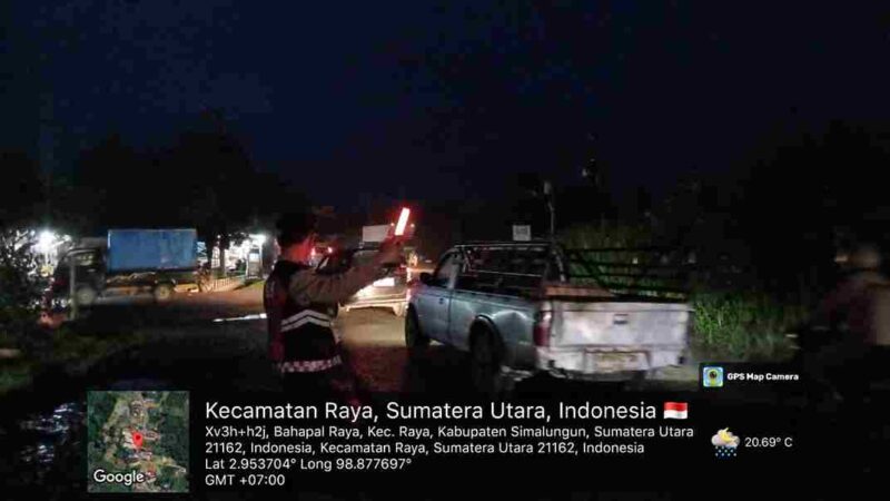 Salah satu petugas Polres Simalungun terlihat sedang mengatur lalu lintas di depan SPBU
