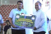 Bupati Asahan, Taufik Zainal Abidin, menerima secara simbolis 1.700 kartu BPJS Ketenagakerjaan dari Bobby Nasution.