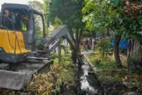 Pemko Medan mengeruk sedimentasi parit Jalan Taduan untuk mencegah genangan.